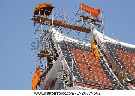 Selective focused, scaffolding support safety for worker renovate, repair Buddhist temple roof. Concept of scaffolding safety, scaffolding construction, Buddhist temple, renovation.