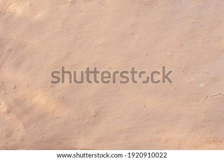 Blurred picture of mud wall and sunlight. clay house structure. soil abstract background