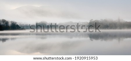 Misty dawn from Nichol End Marina on Derwentwater Royalty-Free Stock Photo #1920915953