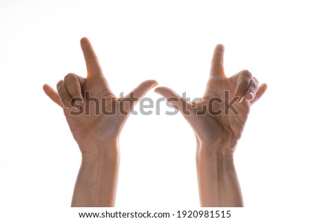 Hand gestures. Thumbs up, that's a cool gesture of the rocker. women's hand. Elegant women's hands, isolated on white, contour lighting, contrast.