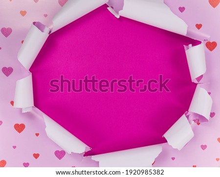 torn pink paper on purple background