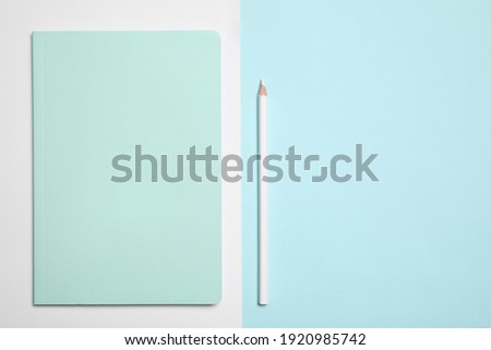 Stylish notebook and pencil on color background, flat lay. Space for text