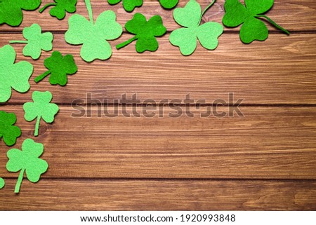 Flat lay composition with clover leaves on wooden background, space for text. St. Patrick's Day celebration