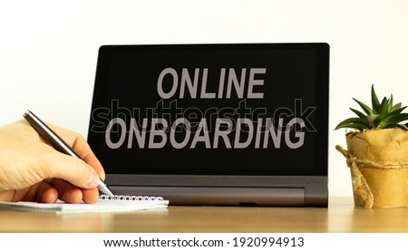 Online onboarding symbol. Tablet with words 'online onboarding'. Online business and onboarding during COVID-19 quarantine. Businessman hand, pen, house plant. Copy space. Online onboarding concept.