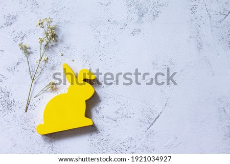Minimal Easter concept. Yellow bunny on Ultimate Gray Color of the year 2021. Top view flat lay background. Copy space.