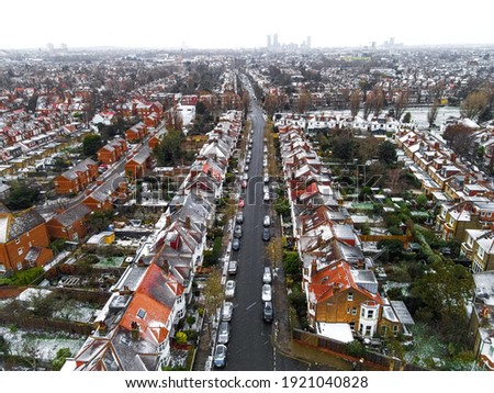 Aerial view of snowy London suburb in winter, UK