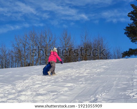 A child is tubing on a snow slide.