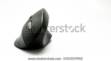 ergonomic vertical black mouse isolated on white background. panoramic photo. gamer mouse, designer mouse. prevention of carpal tunnel disease. body health