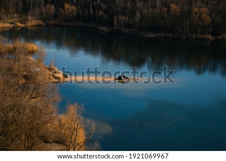 Pictures of a lake surrounded by trees