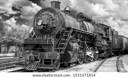 Black and white photo of an old steam engine train Royalty-Free Stock Photo #1921071854