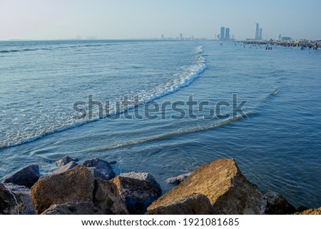 A beautiful picture of seaview wave with buildings karachi sindh.