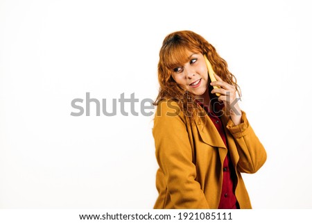 medium shot  of a happy female talking on the phone with yellow coat on an isolated white background. copy space.