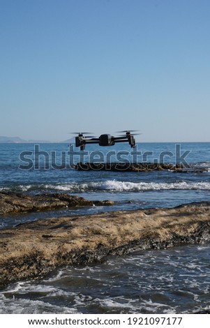 Drone in operation taking pictures of the beach