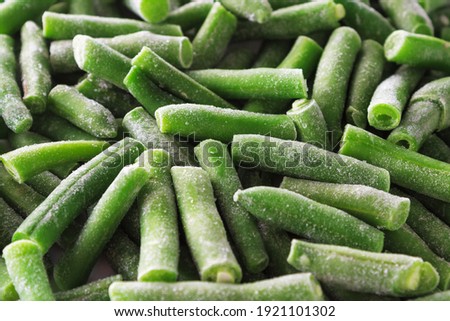 Close-up of frozen green beans covered with ice. Frozen vegetables background.