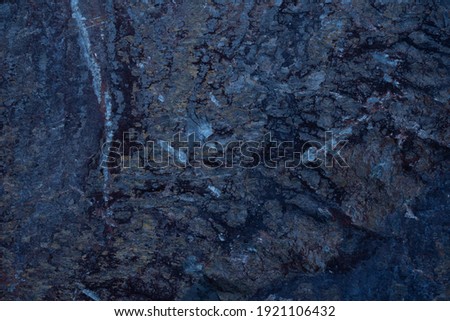 black stone background with bluish veins. texture