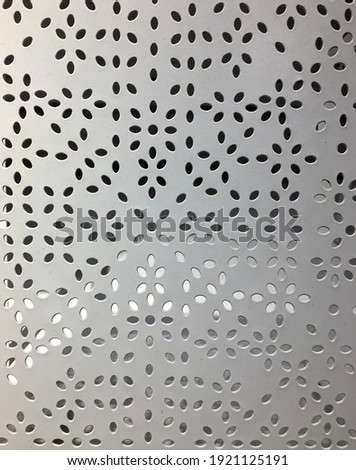 Polka dots on white steel wall, aluminum, for background.