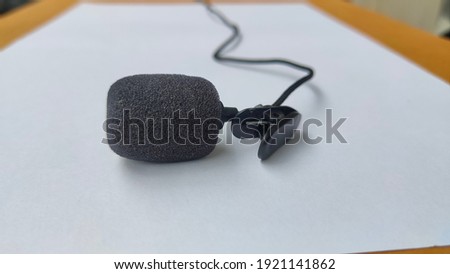 Small lavalier microphone with clip for recorder. Sound recording equipment tools.


