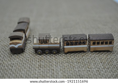 Close up creative shots of small wooden plane and train models handcrafted from wood, around 3cm X 2cm in size