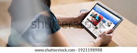 Reading Newspaper Article On Tablet. News Media Royalty-Free Stock Photo #1921198988