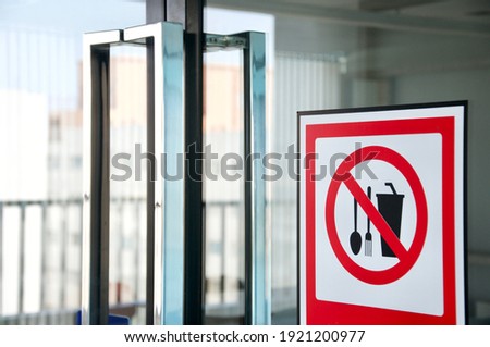Attention Sign of food and drink not allowed bring from outside to restaurant. It is regulation from shopping mall. (Blurred background )