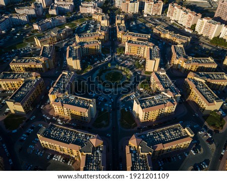 Aerial view of International City in Dubai, United Arab Emirates. Suburban country-themed architecture of residences, business, and tourist attractions outside of Dubai downtown in the UAE
