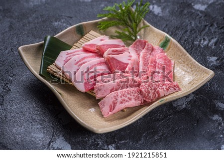 Premium Rare Slices many parts of Wagyu A5 beef with high-marbled texture on stone plate served for Yakiniku (Grilled Meat).