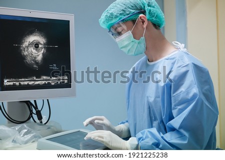 Doctor working at Intravascular ultrasound imaging (IVUS) at cardiac catheterization laboratory room. Royalty-Free Stock Photo #1921225238