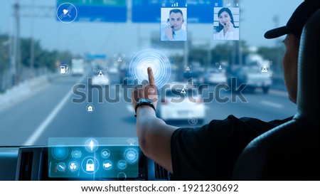 Asian truck driver touch digital display in cockpit. delivery man location connection and communication video call with call center via wireless network. concept  transportation with smart technology Royalty-Free Stock Photo #1921230692