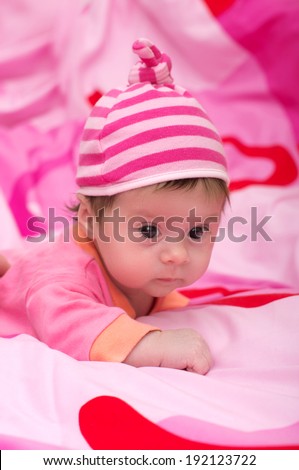 Beautiful baby girl on pink background