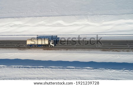 Truck carry oil tank in winter background aerial above drone view