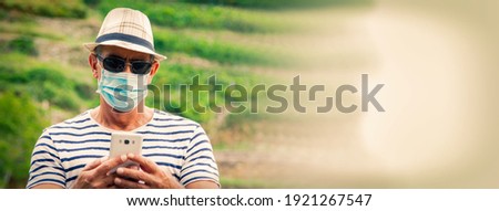 tourist man with medical mask using smartphone