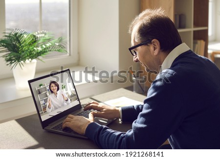 Male patient consulting online doctor at home. Mature man using laptop computer and communicating with nurse or general practitioner. Telemedicine, virtual visit to clinic, video conference concept