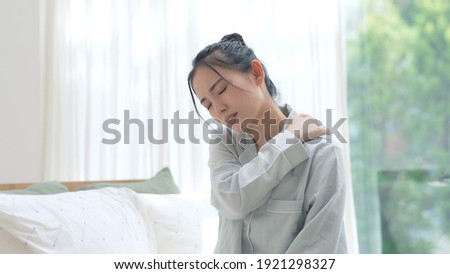 Depressed young asian woman in bedroom. Royalty-Free Stock Photo #1921298327