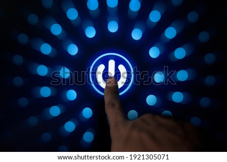 Digitization Idea, Human hand pressing start button to power on the newest technology, Artificial Intelligence, Futuristic, Machine Learning, Launching futuristic machine, People living with Machine Royalty-Free Stock Photo #1921305071