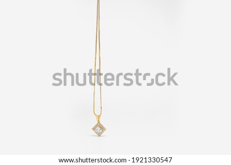 downward circular gold jewel necklace on a very elegant white background