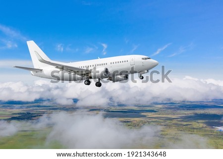 Jet passenger plane is approaching landing at the airport Royalty-Free Stock Photo #1921343648