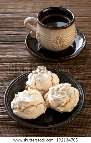 Meringue cookies and cup of aromatic coffee 