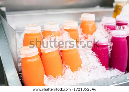 Mixed orange juice cold cups on ice in the flea market