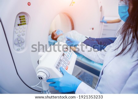 Radiologist with a female patient in the room of computed tomography Royalty-Free Stock Photo #1921353233
