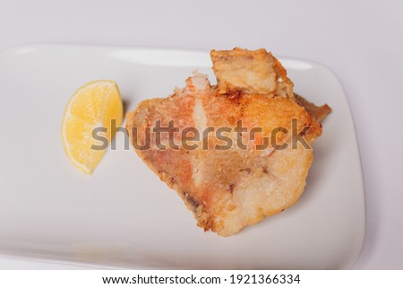 Battered fish fillet isolated over white background.