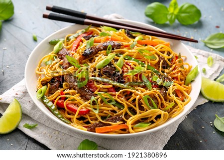 Stir fry noodles with beef and vegetable in white bowl. asian style food Royalty-Free Stock Photo #1921380896