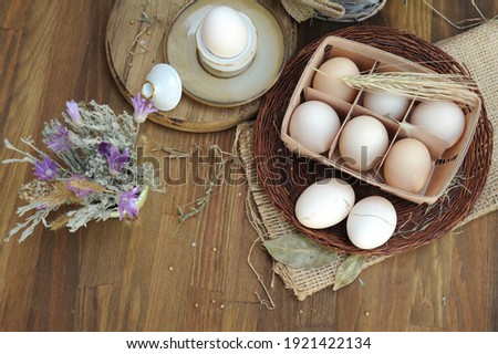 Fresh farm eggs in basket on a wooden rustic background