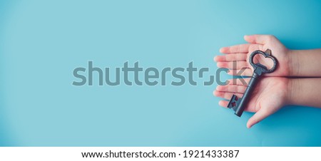 Unlock brain potential in kid.Child girl hands holding Key.Key for safety, Lock, Unlock, Security, secret, DNA, Success, Entrance, Protect kid and children.Child development education.Child rights.crc Royalty-Free Stock Photo #1921433387