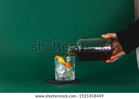 Pouring a prebatched cocktail in a studio