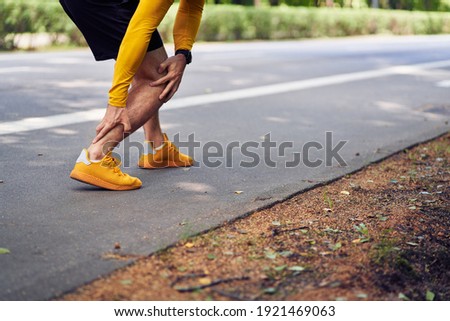 Achilles tendon injury in runners concept. Royalty-Free Stock Photo #1921469063