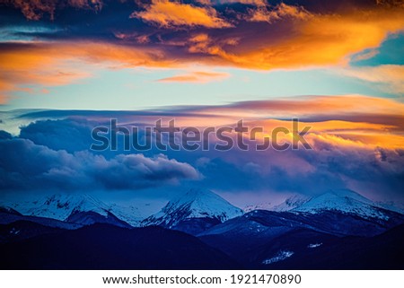 Colorful and stunning sunset sky over the Retezat Massif. Photo taken on 30th of January 2021 in Retezat massif part of the Romanian Carpathian Mountains.  Royalty-Free Stock Photo #1921470890