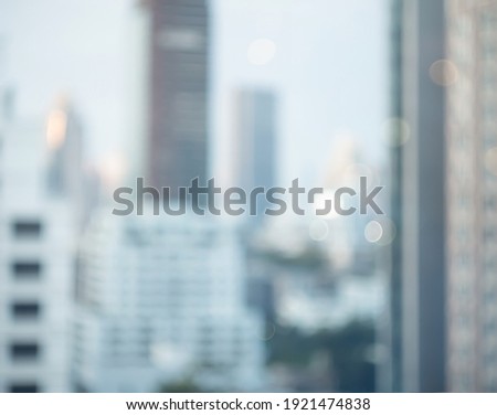 Blurry focus city hotel corporate building in blue morning business background. Cityscape skyline light outside office window grey sky view. Day bokeh winter bank company blur backdrop outdoor.