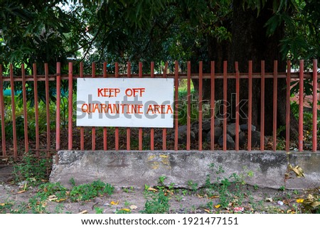 Keep Out Quarantine Area handmade banner sign on metallic fence. COVID-19 hospital surrounding wall. Coronavirus pandemic quarantine place. Keep off banner sign. South Asia Philippines lockdown
