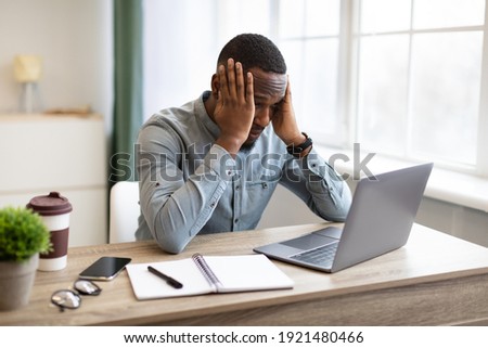 Stressful Job. Stressed African Businessman At Laptop Touching Head Having Problem At Workplace Sitting In Modern Office. Crisis And Entrepreneurship Business Issues, Headache Concept Royalty-Free Stock Photo #1921480466