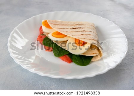 Tortillas with various fillings of lightly salted trout, spinach and boiled eggs for breakfast, lunch or dinner. Food trend. Delicious and healthy snack. Royalty-Free Stock Photo #1921498358